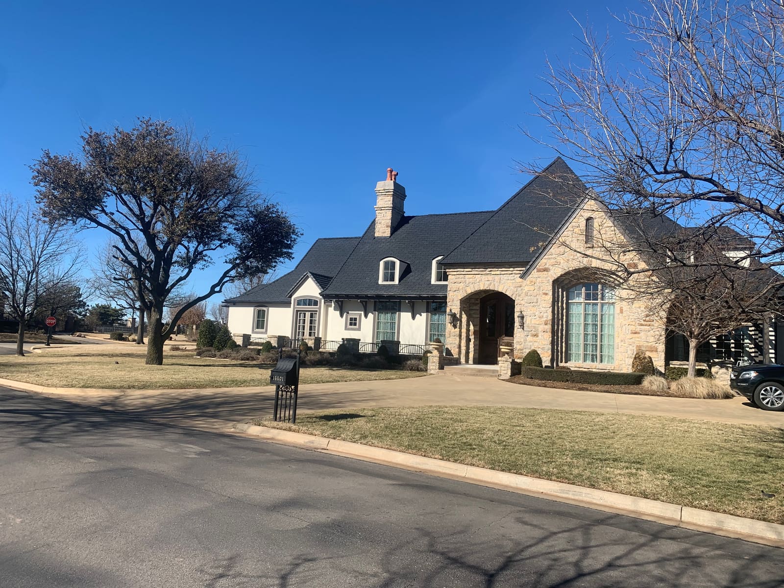A finished slate roof on a stone home, ready for another Oklahoma winter