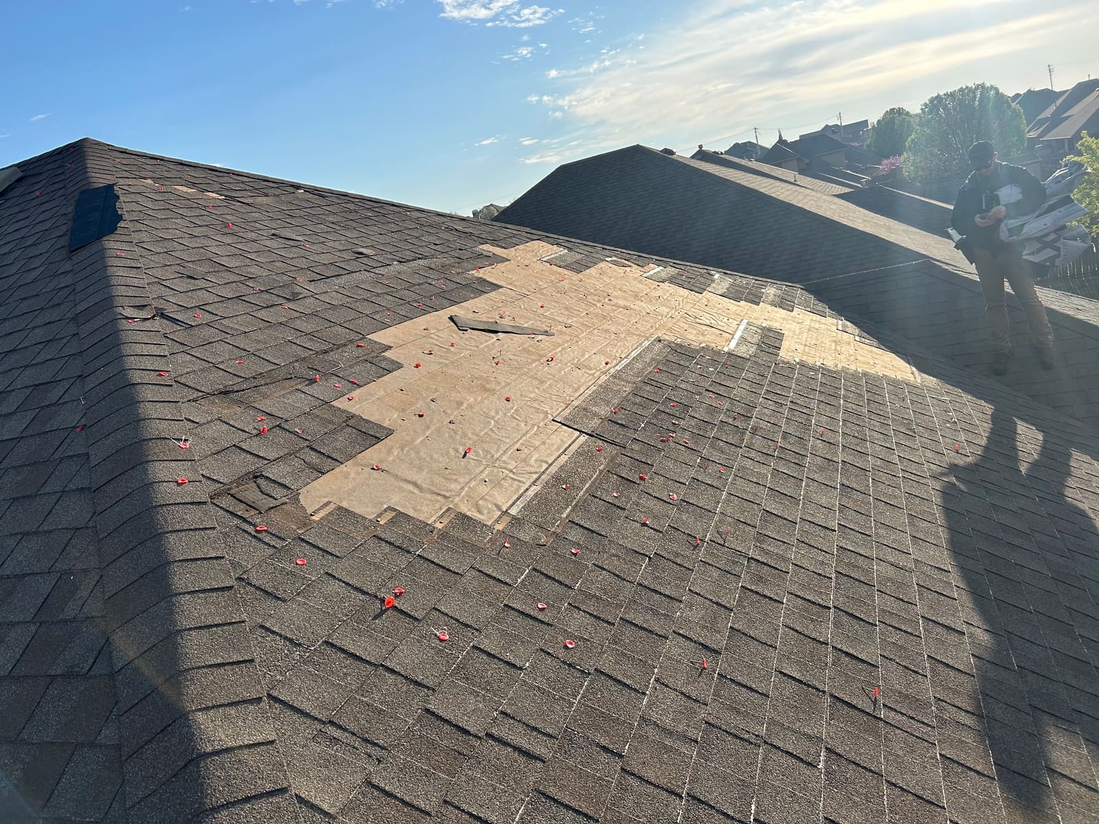 Hail damage documented with test squares, adjuster on site