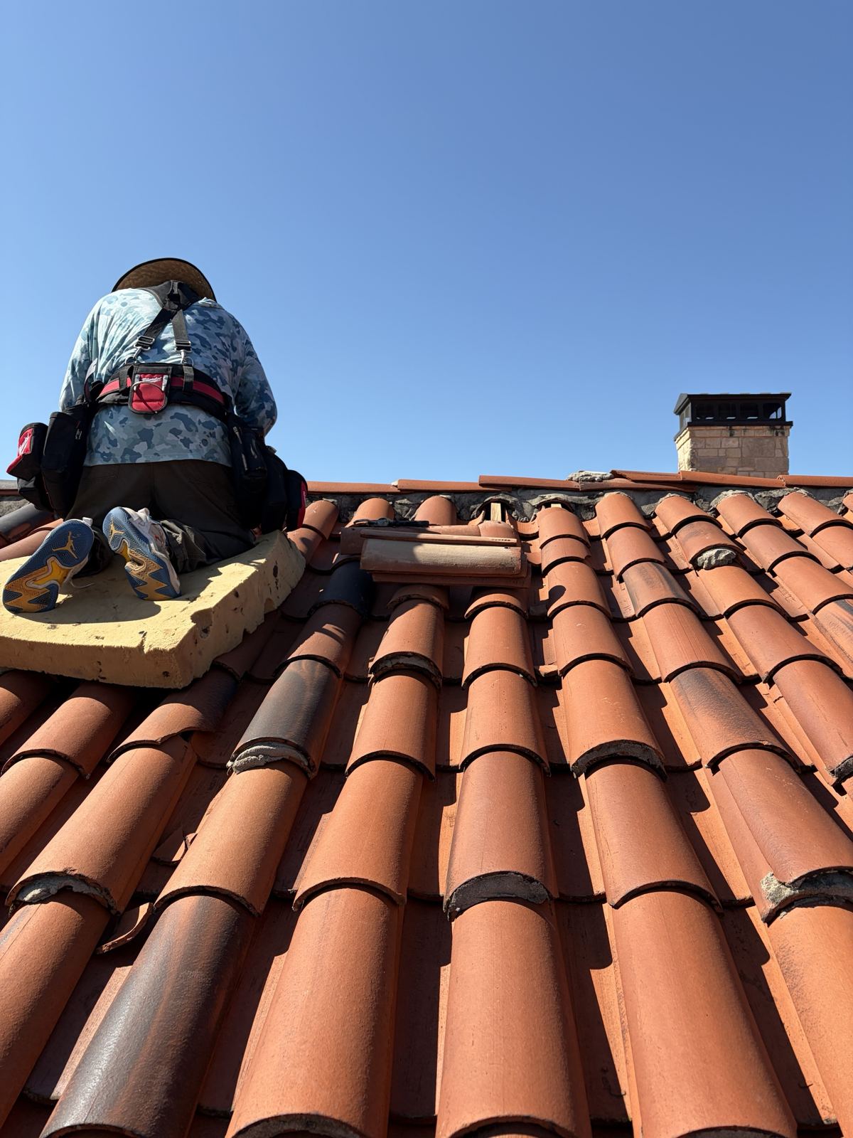 Norman tile repair after the windstorm: ridge reset and broken tile replaced the same week